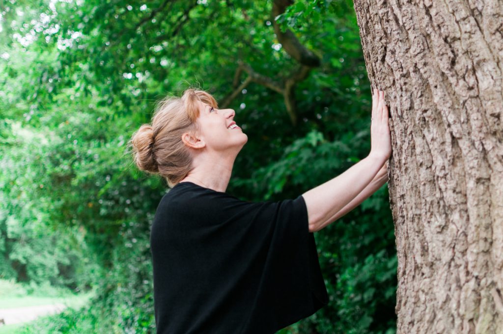 Lindsey Hood touching tree